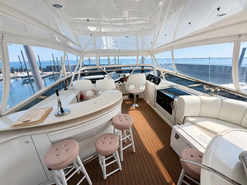 Slide: The Image of The image shows the spacious deck of a 2006 Marquis 65 yacht with elegant seating. - 48
