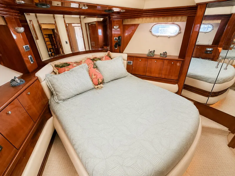 Slide: The Image of Luxurious cabin with a large bed, wooden furnishings, and a porthole on the wall. - 20