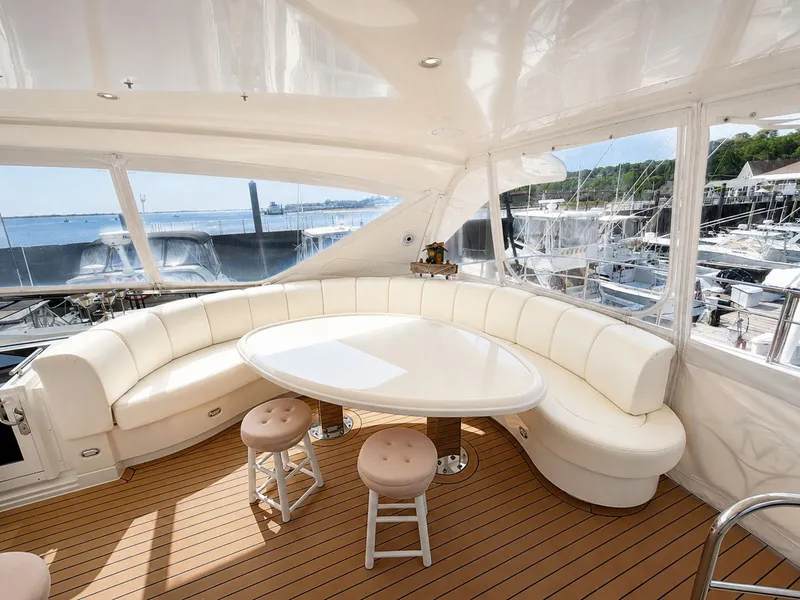 Slide: The Image of The 2006 Marquis 65 features an elegant white seating area with an oval table and stools. - 47