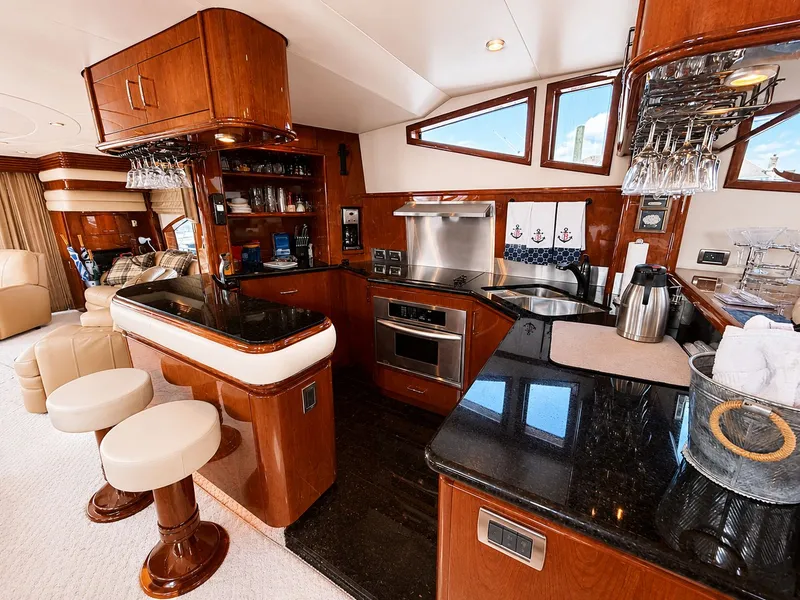 Slide: The Image of The luxurious galley of a 2006 Marquis 65 yacht with wood paneling and modern appliances. - 7
