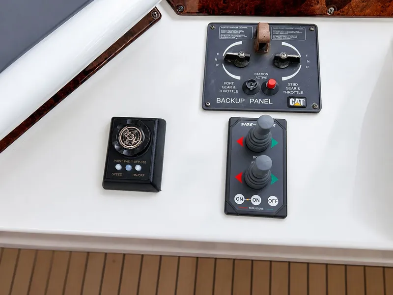 Slide: The Image of The image shows the control panel of a 2006 Marquis 65 with various controls. - 43