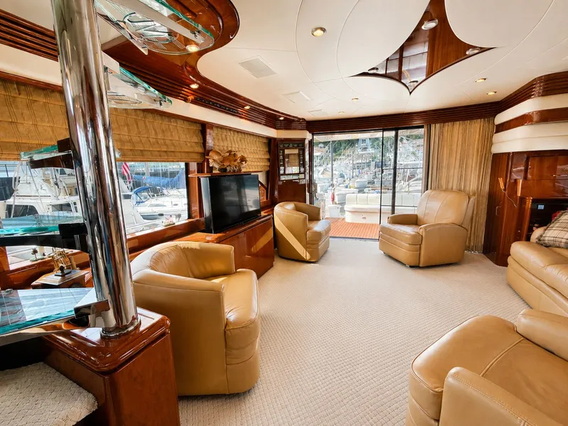 Slide: The Image of Luxurious salon with leather chairs and large windows on a 2006 Marquis 65 yacht. - 15