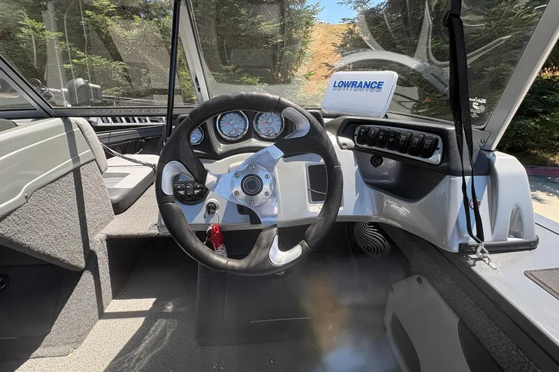 Slide: The Image of 2018 Tracker Targa V-18 Combo boat dashboard with steering wheel and Lowrance device. - 9
