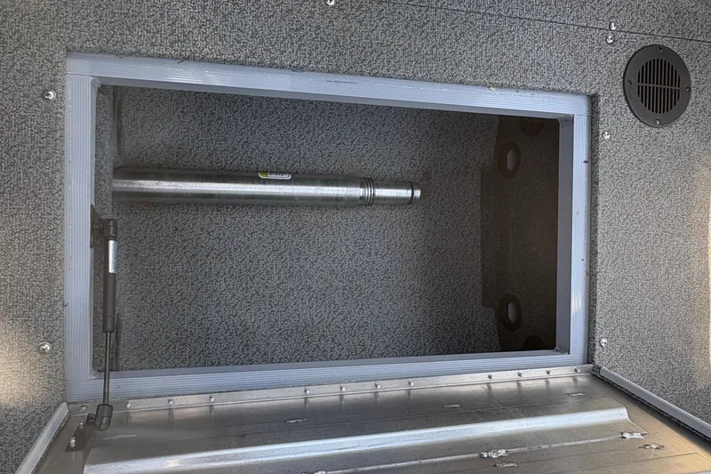Slide: The Image of 2018 Tracker Targa V-18 Combo storage compartment with textured interior and hydraulic support. - 27