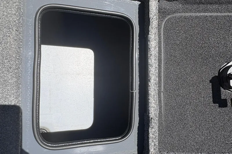 Slide: The Image of Open storage compartment on 2018 Tracker Targa V-18 Combo boat. - 29