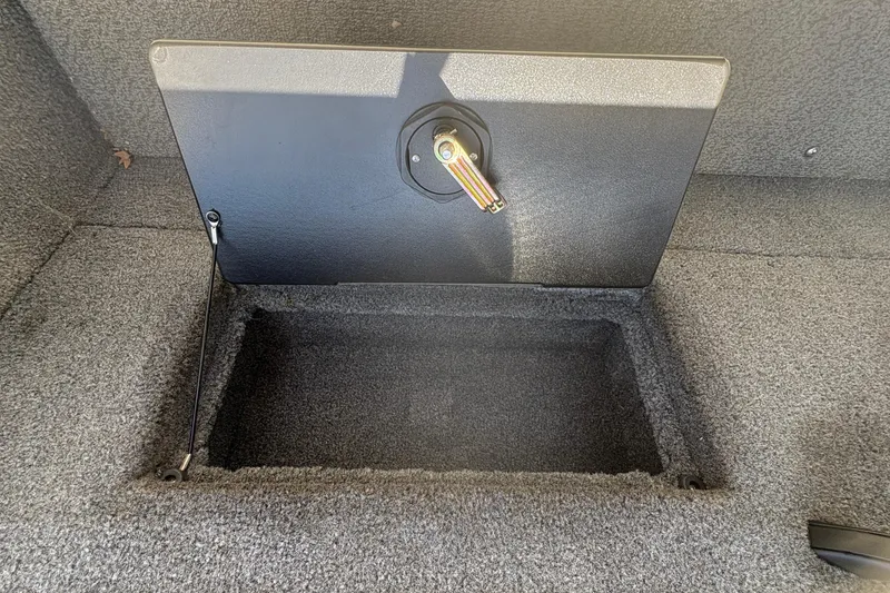 Slide: The Image of Storage compartment in 2018 Tracker Targa V-18 Combo boat, featuring a secure latch. - 23