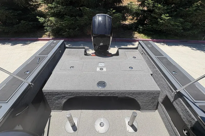 Slide: The Image of 2018 Tracker Targa V-18 Combo boat interior with motor, featuring spacious deck and storage compartments. - 8