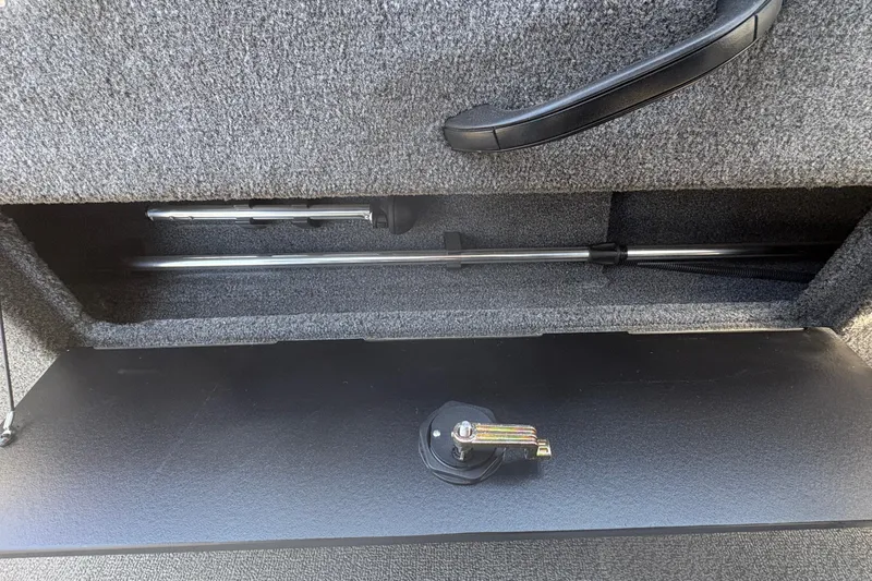 Slide: The Image of 2018 Tracker Targa V-18 Combo storage compartment with handle and lock mechanism. - 21