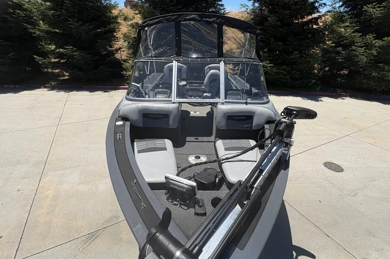 Slide: The Image of 2018 Tracker Targa V-18 Combo boat with seating and fishing equipment on a sunny day. - 6