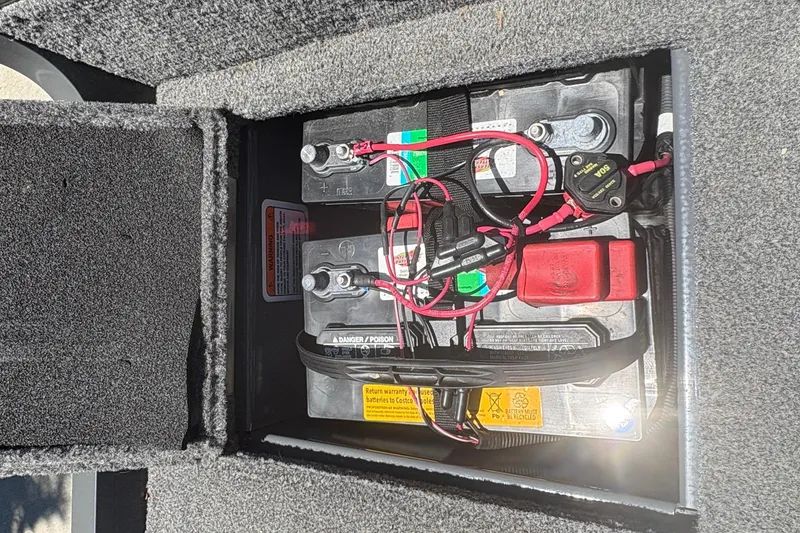 Slide: The Image of Battery compartment of a 2018 Tracker Targa V-18 Combo boat, showing wiring and connections. - 28