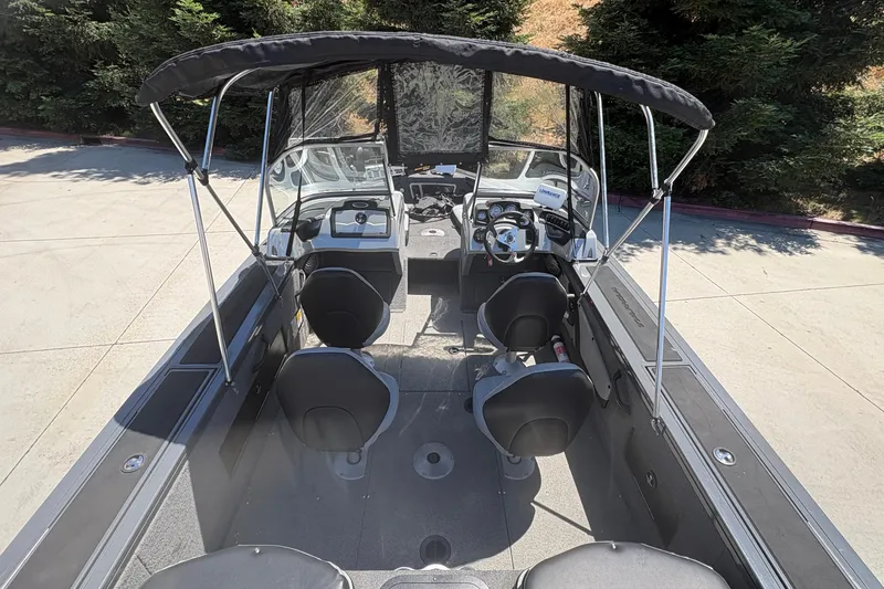 Slide: The Image of 2018 Tracker Targa V-18 Combo boat interior with seating and canopy. - 12