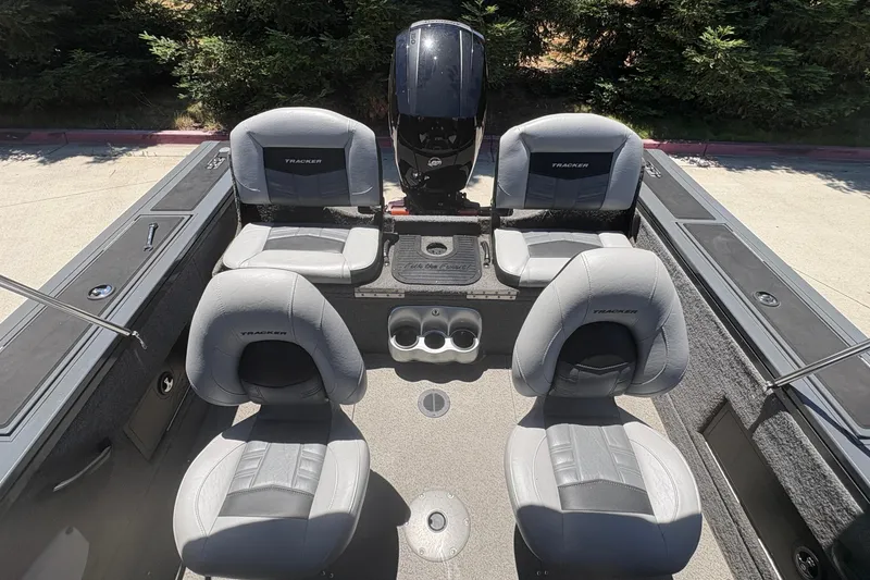 Slide: The Image of 2018 Tracker Targa V-18 Combo boat interior with four gray seats and motor. - 15