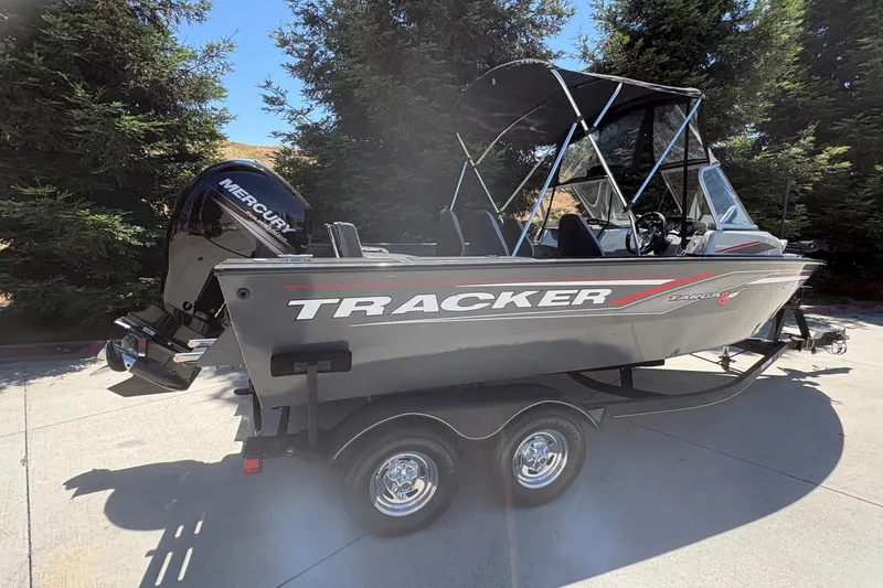 Slide: The Image of 2018 Tracker Targa V-18 Combo boat with Mercury engine on trailer, parked outdoors. - 4