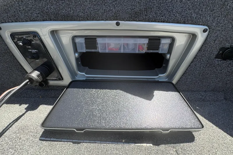 Slide: The Image of Storage compartment in 2018 Tracker Targa V-18 Combo boat, featuring organized tackle box. - 16