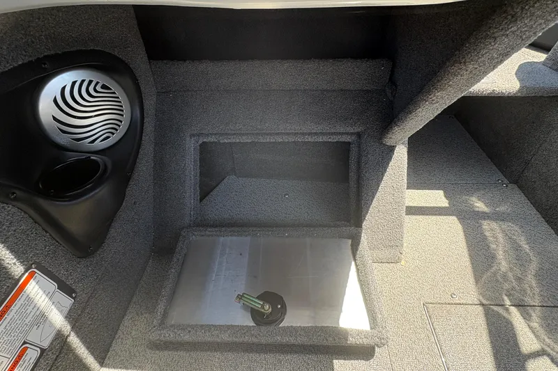 Slide: The Image of Interior of 2018 Tracker Targa V-18 Combo boat, featuring speaker and storage compartment. - 20
