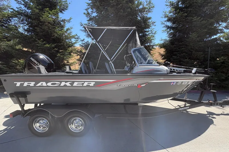 Slide: The Image of 2018 Tracker Targa V-18 Combo boat on trailer, parked outdoors. - 5