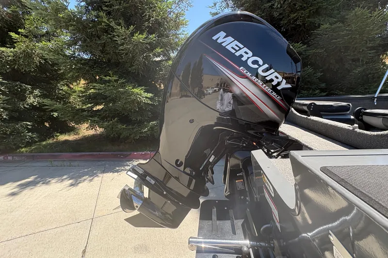 Slide: The Image of 2018 Tracker Targa V-18 Combo with Mercury FourStroke engine in outdoor setting. - 26
