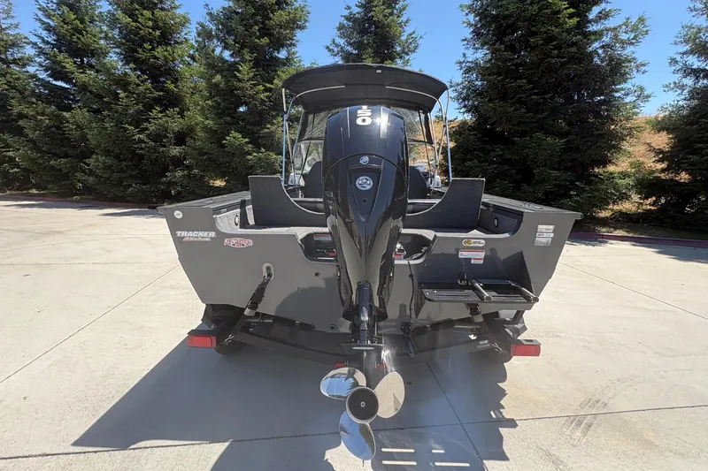 Slide: The Image of 2018 Tracker Targa V-18 Combo boat with powerful outboard motor, parked outdoors. - 7