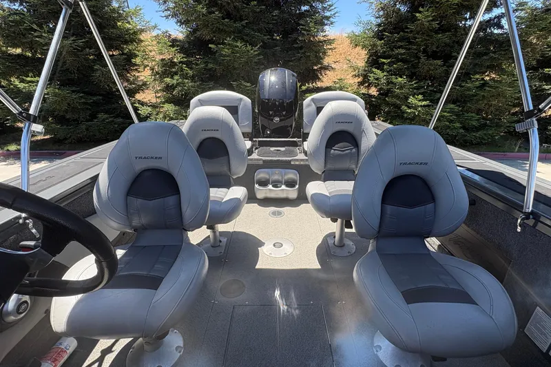 Slide: The Image of 2018 Tracker Targa V-18 Combo boat interior with four gray seats and steering wheel. - 14