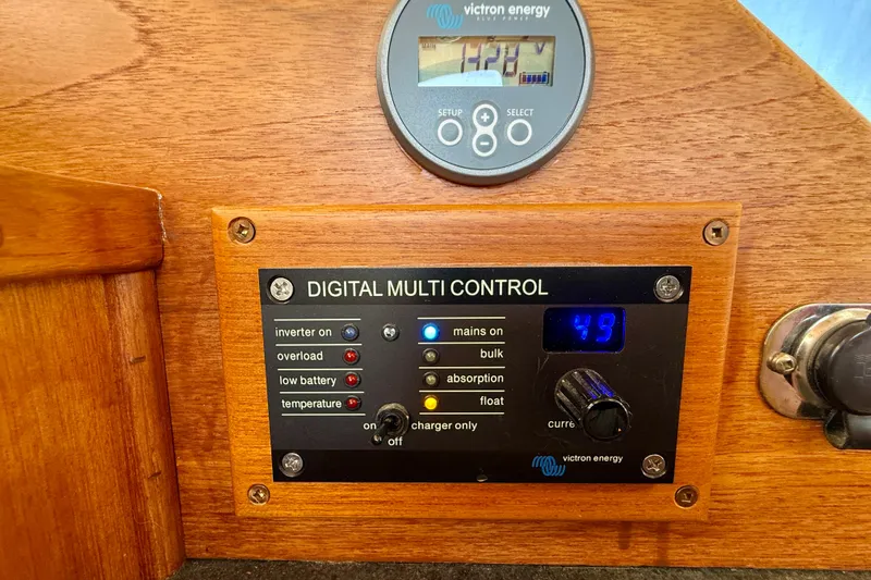 Slide: The Image of Victron Energy Digital multi-control inverter panel featuring Victron Energy battery status display. - 35