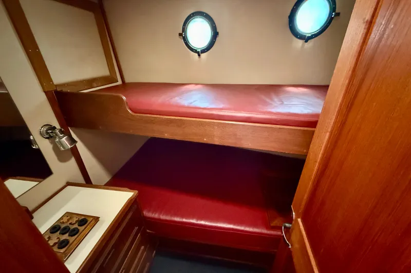 Slide: The Image of Cozy cabin with red bunk beds in a 2000 Nordic Tug 37 boat. - 53