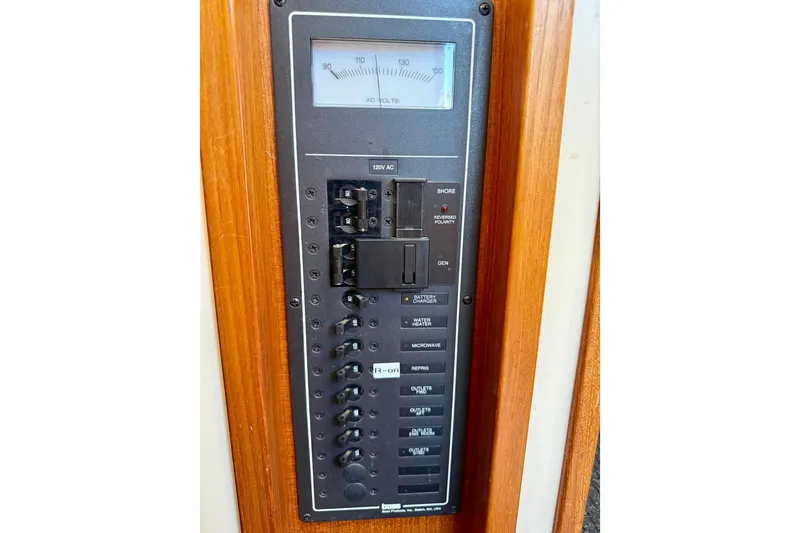 Slide: The Image of Electrical panel on a 2000 Nordic Tug 37 boat, featuring voltage meter and switches. - 68