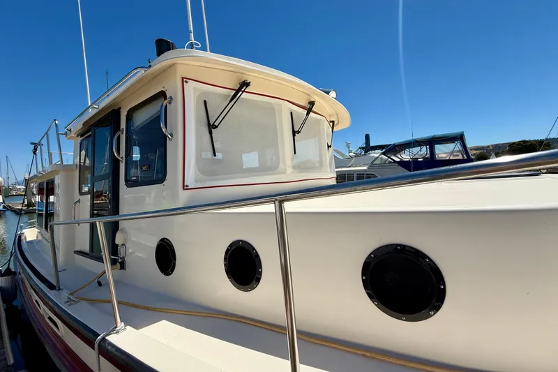 Slide: The Image of 2000 Nordic Tug 37 boat docked, showcasing its classic design and sturdy build. - 77
