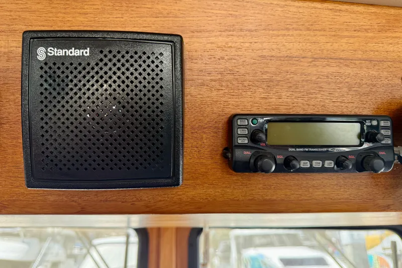 Slide: The Image of Standard speaker and transceiver on 2000 Nordic Tug 37 wooden dashboard. - 62