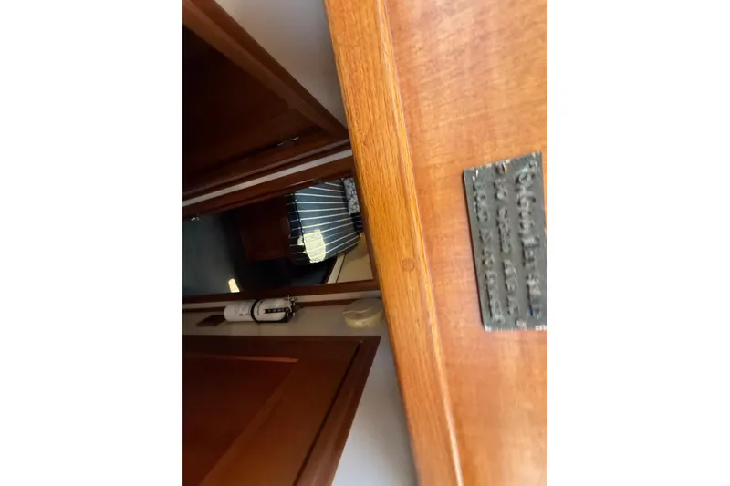 Slide: The Image of Interior view of a 2000 Nordic Tug 37, showcasing wooden details and a cabin doorway. - 81