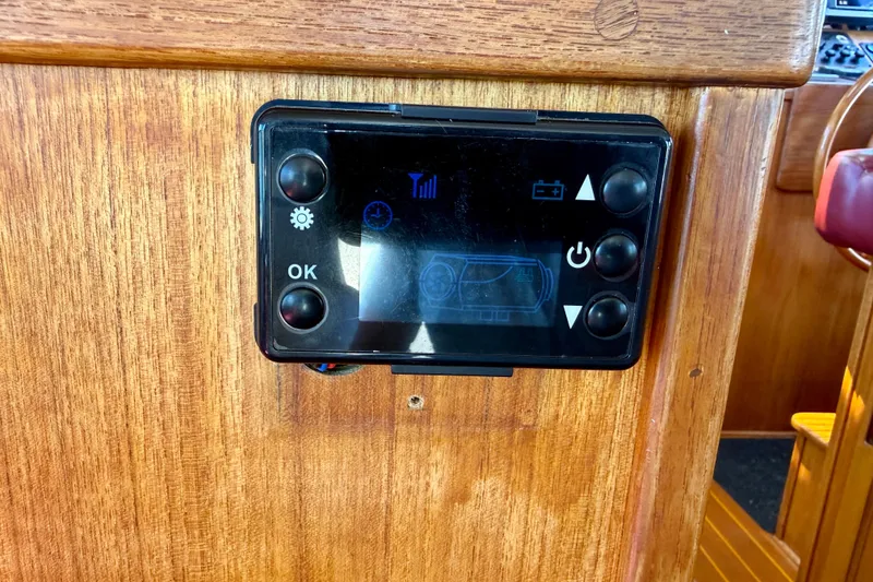 Slide: The Image of Control panel on a 2000 Nordic Tug 37 boat, mounted on wooden interior. - 58