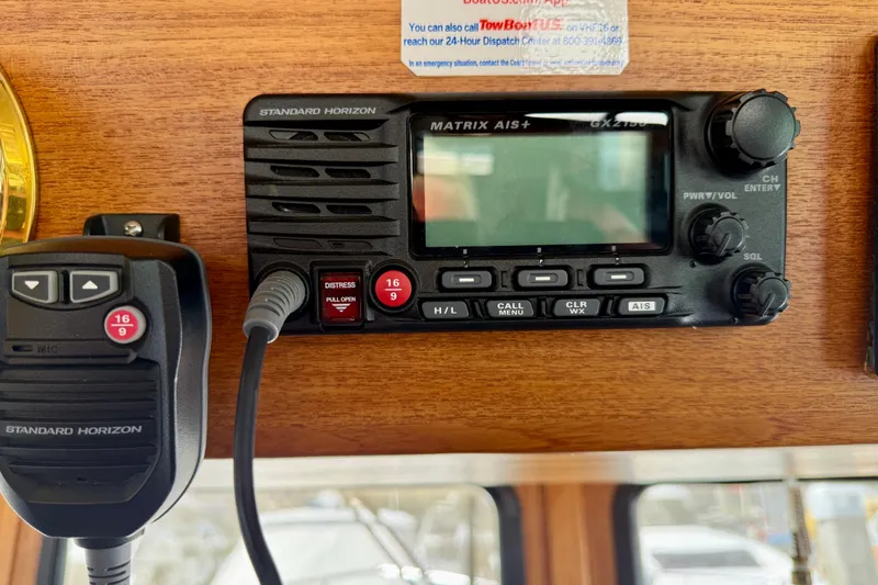 Slide: The Image of VHF radio system on a 2000 Nordic Tug 37 boat dashboard. - 61