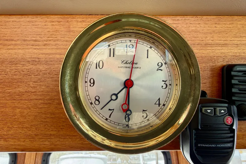 Slide: The Image of Brass nautical clock on Nordic Tug 37, 2000 model, with radio equipment nearby. - 60