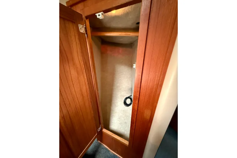 Slide: The Image of Wooden closet interior on a 2000 Nordic Tug 37 boat. - 47