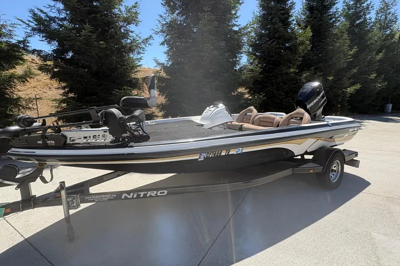 Slide: The Image of 2008 Nitro Z-7 boat on trailer, parked outdoors with trees in background. - 6