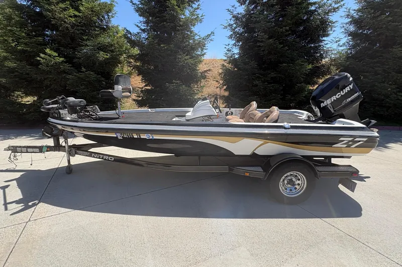Slide: The Image of 2008 Nitro Z-7 fishing boat with Mercury engine, parked on a driveway. - 5
