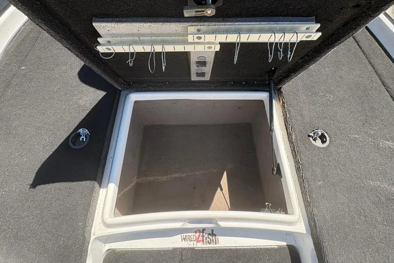 Slide: The Image of Open storage compartment on a 2008 Nitro Z-7 boat, featuring hooks and carpeted interior. - 20