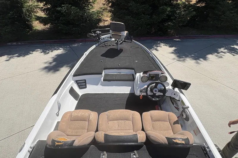 Slide: The Image of 2008 Nitro Z-7 boat interior with steering wheel and seating, parked outdoors. - 13