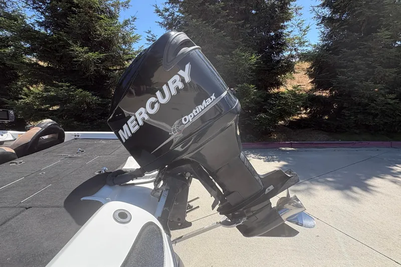 Slide: The Image of Mercury OptiMax outboard motor on a 2008 Nitro Z-7 boat, parked outdoors. - 9