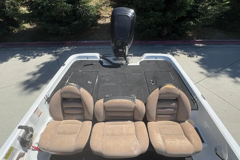 Slide: The Image of 2008 Nitro Z-7 boat interior with three beige seats and motor. - 16