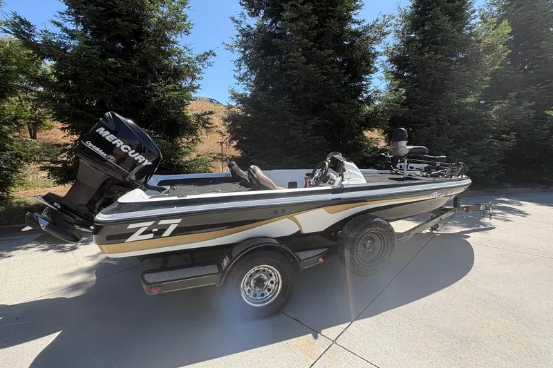 Slide: The Image of 2008 Nitro Z-7 boat with Mercury engine on trailer, surrounded by trees. - 3
