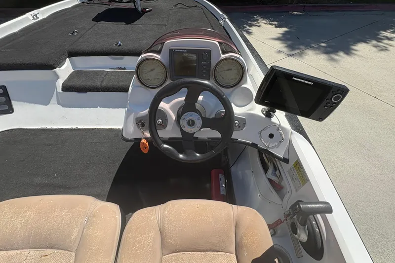 Slide: The Image of 2008 Nitro Z-7 boat cockpit with steering wheel, gauges, and Humminbird fish finder. - 11