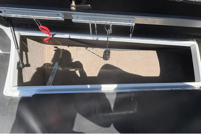 Slide: The Image of Open storage compartment in a 2008 Nitro Z-7 boat, showing interior details and shadows. - 21