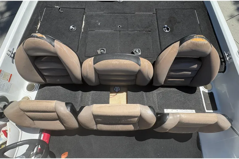 Slide: The Image of Interior seating of a 2008 Nitro Z-7 boat, featuring worn leather seats. - 15