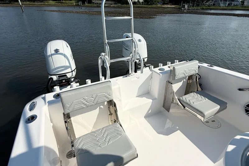Slide: The Image of 2023 Twin Vee 260 GFX CC boat with dual Suzuki engines and comfortable seating. - 15