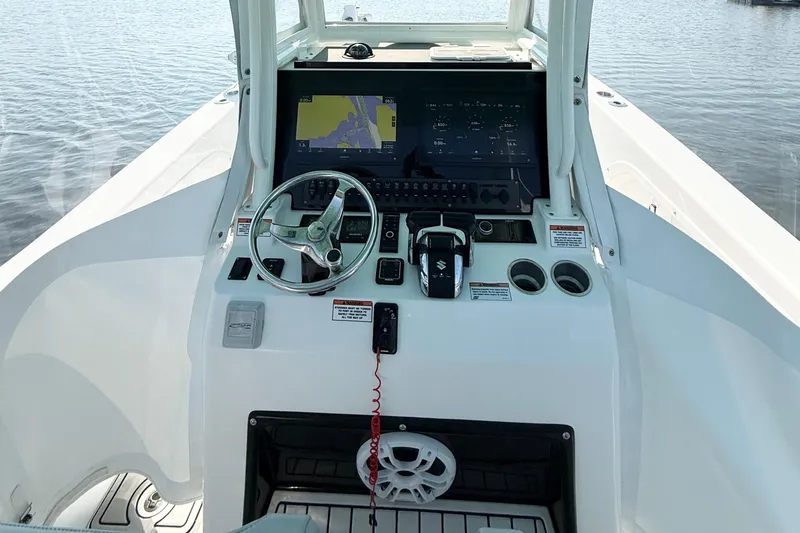 Slide: The Image of 2023 Twin Vee 260 GFX CC boat helm with steering wheel and navigation display. - 19