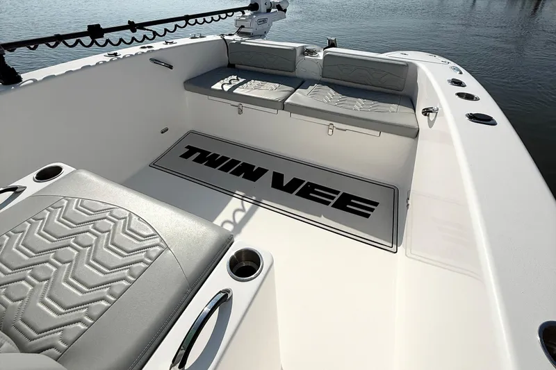 Slide: The Image of 2023 Twin Vee 260 GFX CC boat interior with cushioned seating and logo mat. - 17