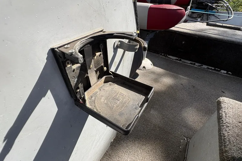 Slide: The Image of Interior of a 1997 Duroboat 14rlw showing a foldable seat and carpeted floor. - 17