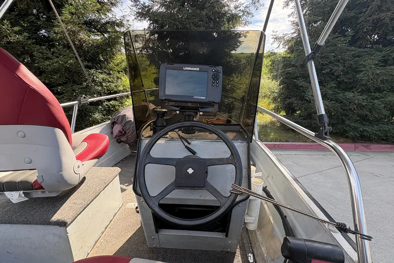 Slide: The Image of 1997 Duroboat 14rlw interior with steering wheel and navigation system. - 12