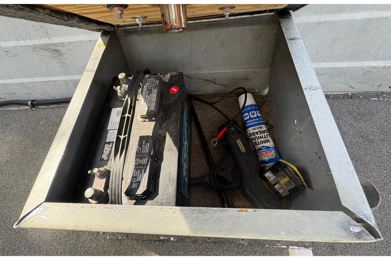 Slide: The Image of Battery compartment of a 1997 Duroboat 14rlw with tools and lubricant. - 18