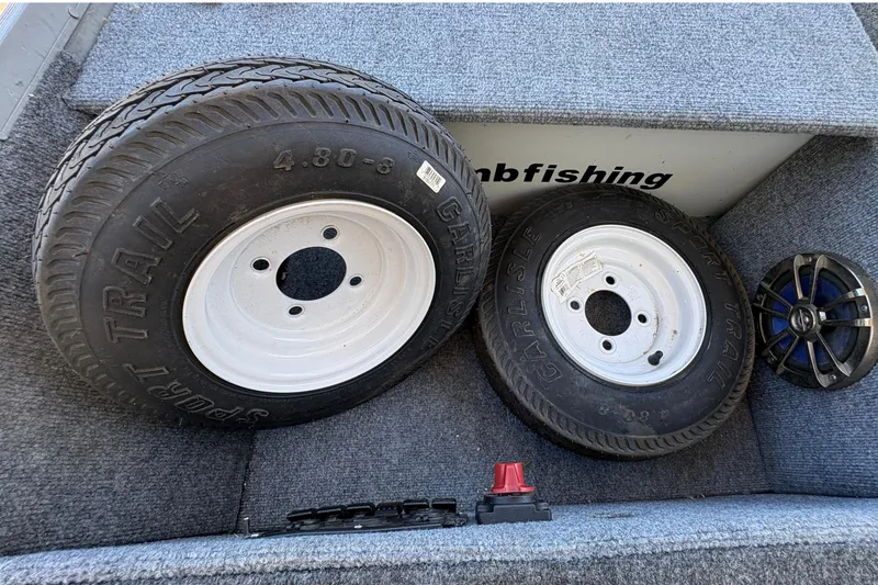 Slide: The Image of Two Carlisle Sport Trail tires in a Grumman 1065 boat, 1994 model. - 11